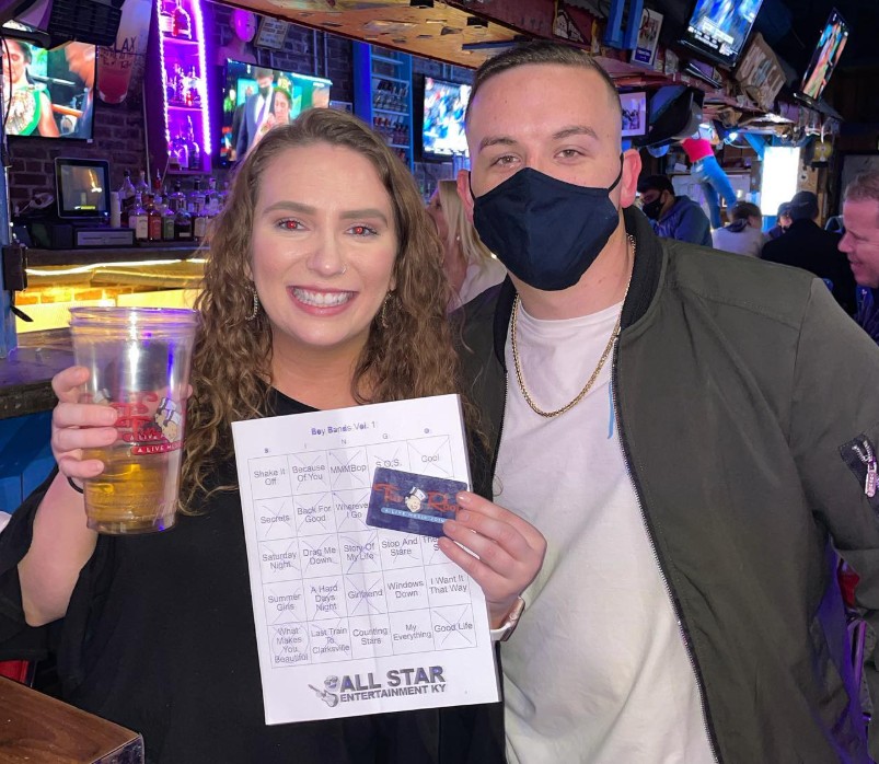 Music bingo winners showing off their card