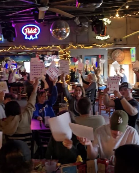 Trivia night hosts leading the crowd