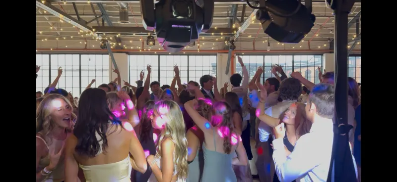 Guests packing the dance floor under string lights
